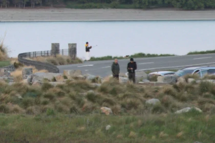 Before: two people standing on the lakeside road.